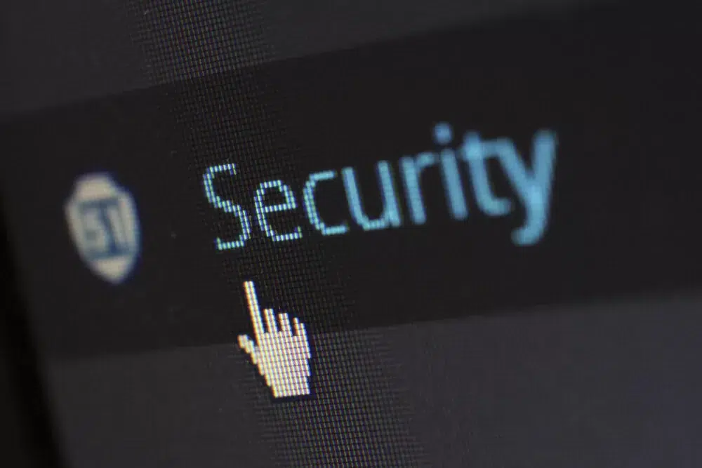 Computer hand icon clicking on the word security